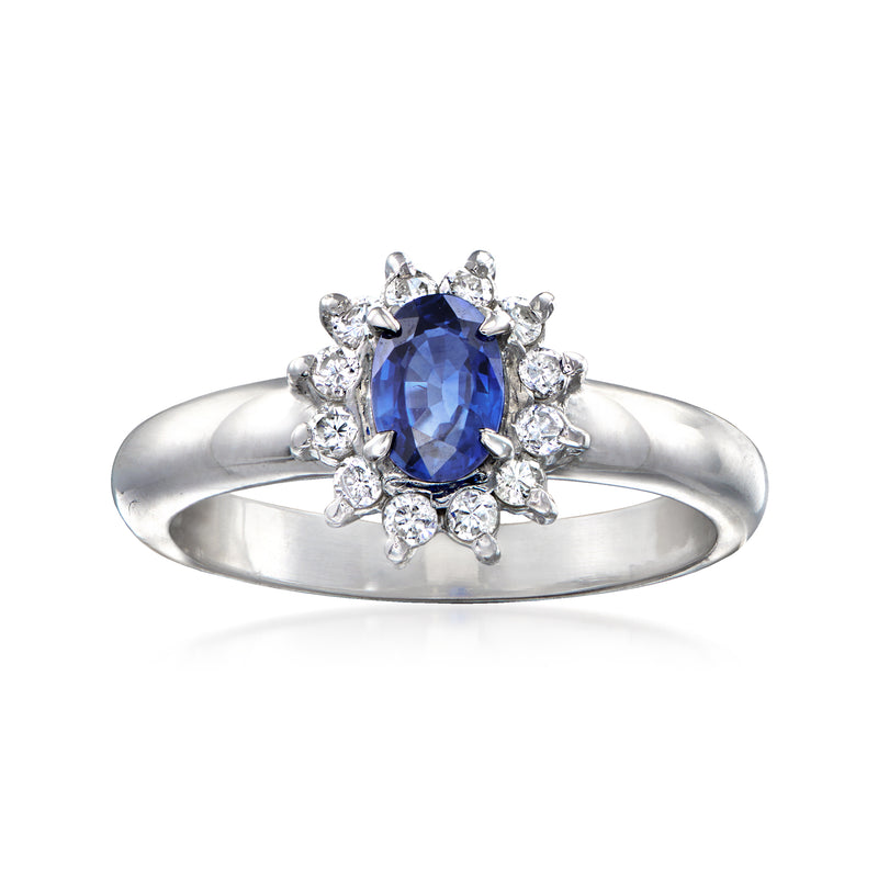 Platinum sapphire and diamond halo ring with oval blue center stone and round diamond accents