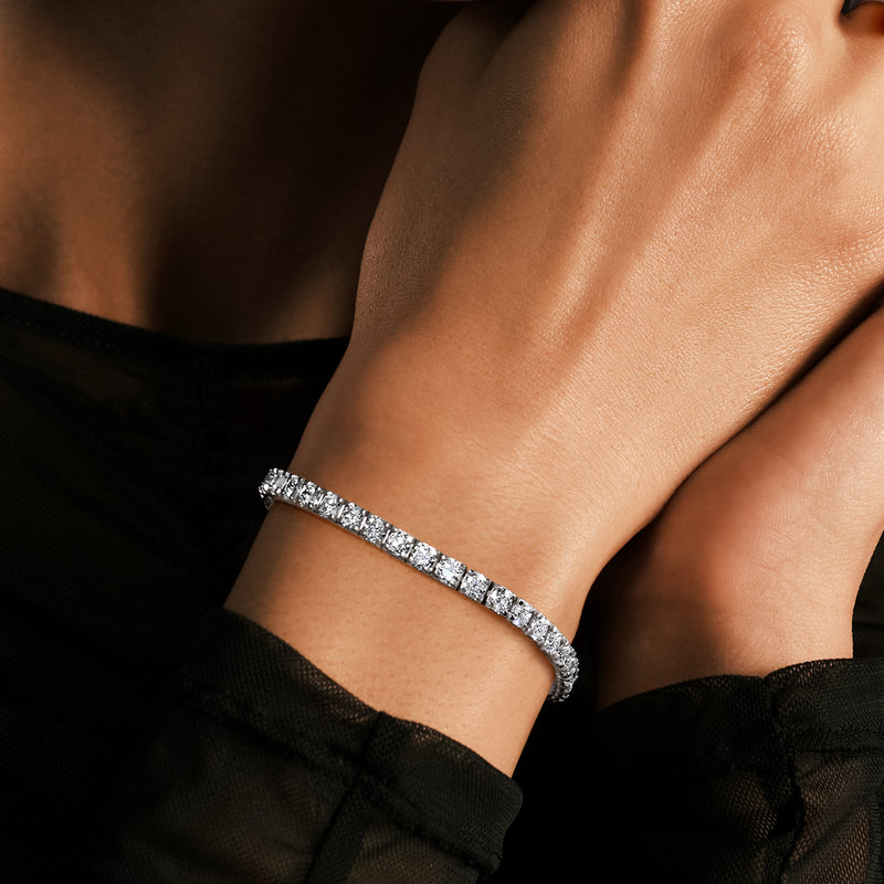 Slim diamond tennis bracelet in 14kt white gold with round stones on wrist
