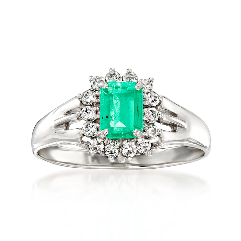 Platinum vintage emerald-cut green gemstone ring with diamond halo and side diamonds