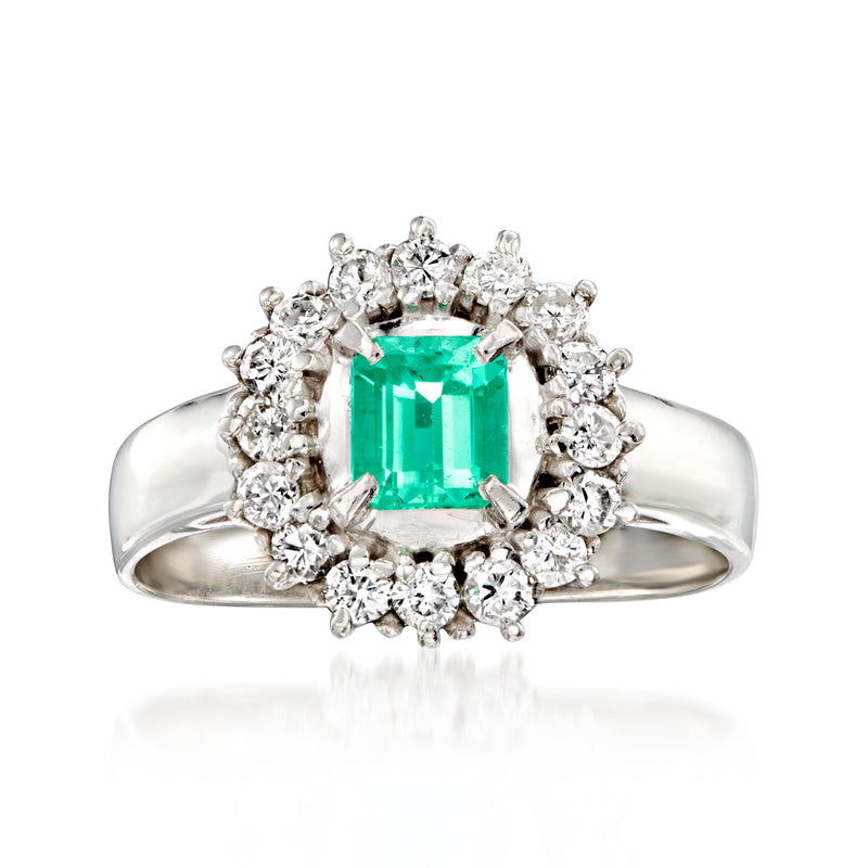 Platinum ring with emerald-cut green gemstone and diamond halo, split prong setting