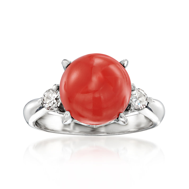 Platinum ring with red coral cabochon and round diamond side accents