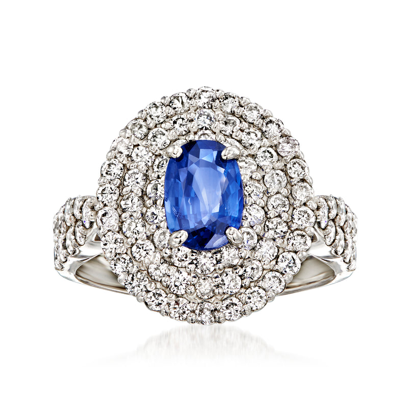 Platinum sapphire and diamond ring with oval blue center stone and diamond halo