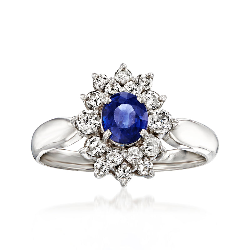 Platinum vintage ring with round blue sapphire center and halo of sparkling diamonds