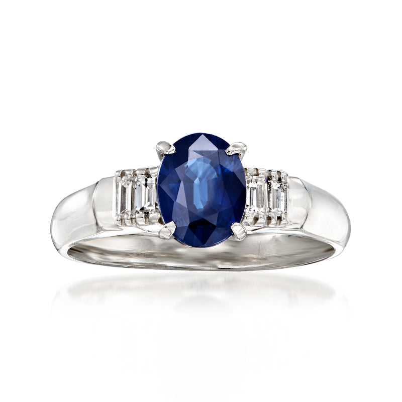 Platinum sapphire and diamond ring with oval blue center stone and side baguette accents
