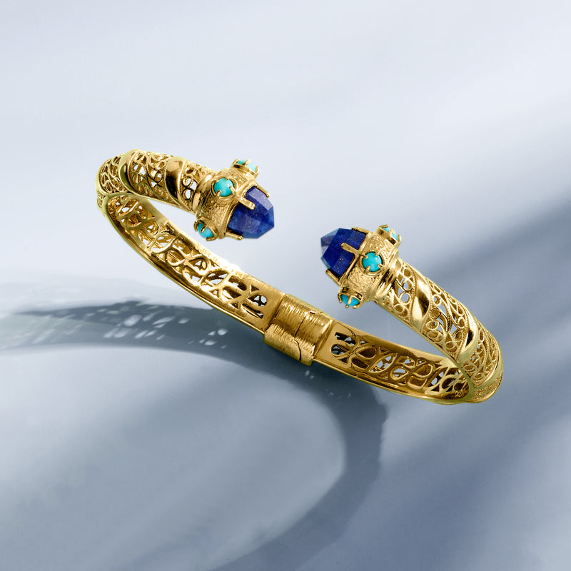 Gold cuff bracelet, angled view with blue lapis-like stone and turquoise studs
