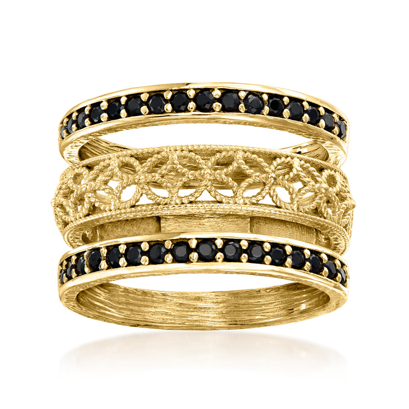 Three gold over sterling rings with black bezel bands and scrollwork center