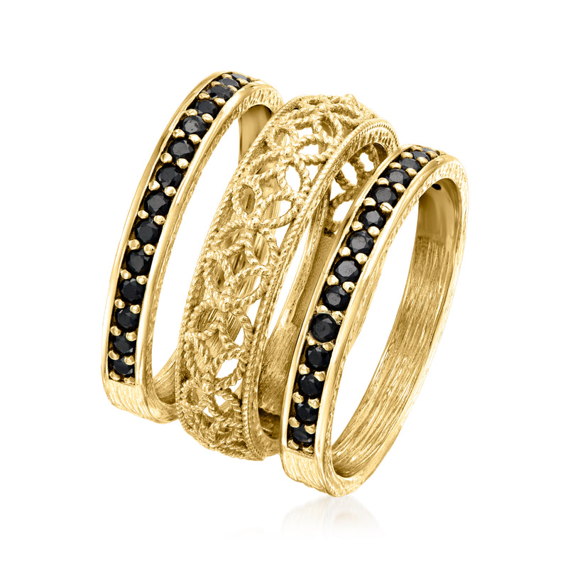 Stacked three gold rings: black stone band and ornate scrollwork detail