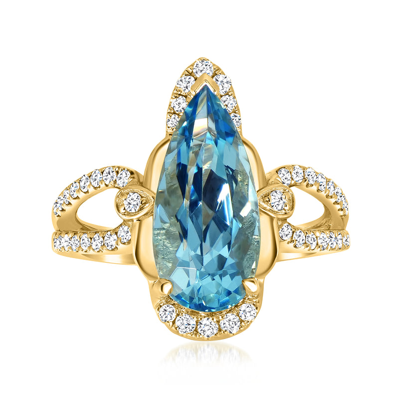 Yellow gold ring with pear-cut aquamarine and diamond halo accents on shoulders