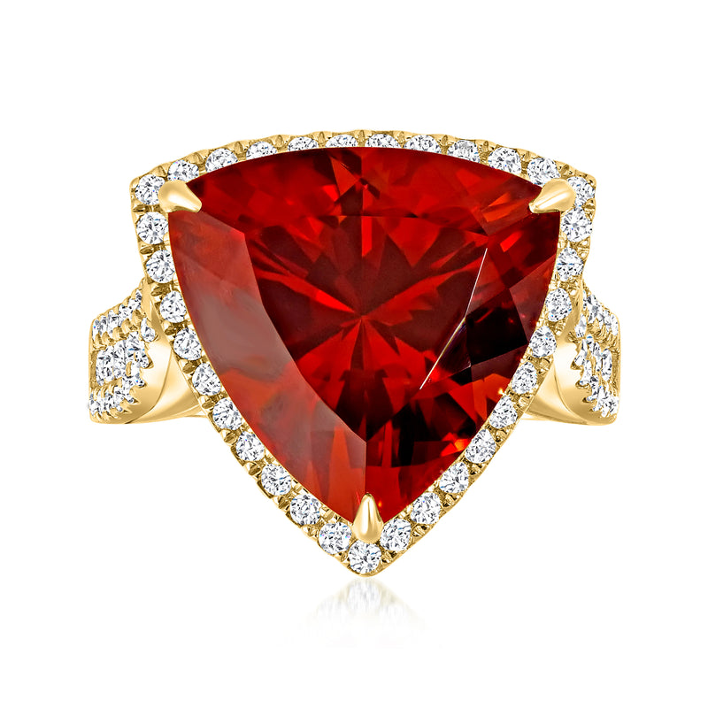 18k yellow gold ring with large orange-red gemstone and diamond halo