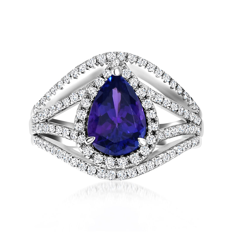 Platinum ring with pear-cut blue tanzanite center and diamond halo on split shank