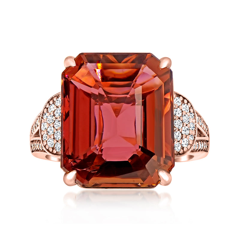 Rose gold ring with large pink tourmaline-style emerald-cut center and diamond halo