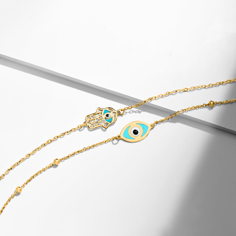 Gold evil eye bracelet close-up with multicolor enamel eye charm on link chain