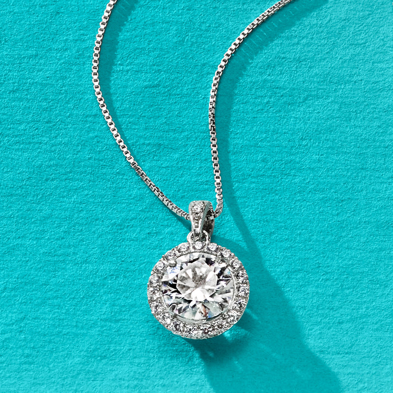 Round sterling silver moissanite pendant with halo and faceted center on chain