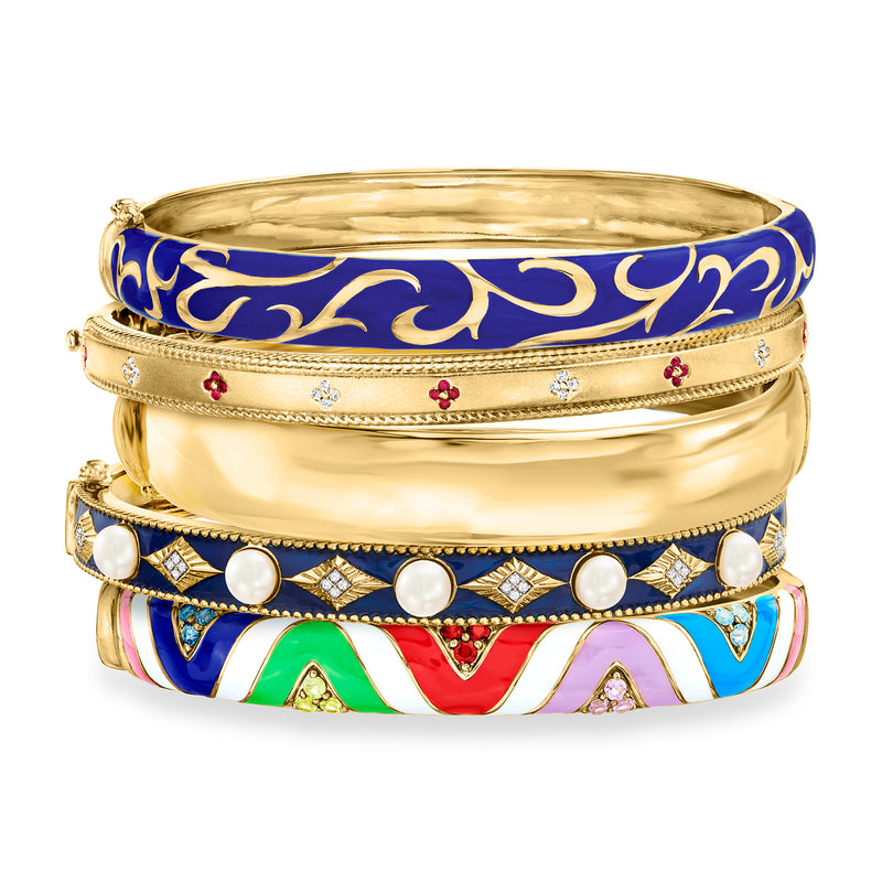 Set of five gold-tone bangle bracelets with blue enamel, white bead accents, and stones