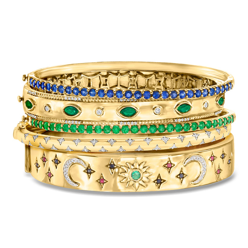Stack of five gold-tone bangles with blue, green, and crystal star accents