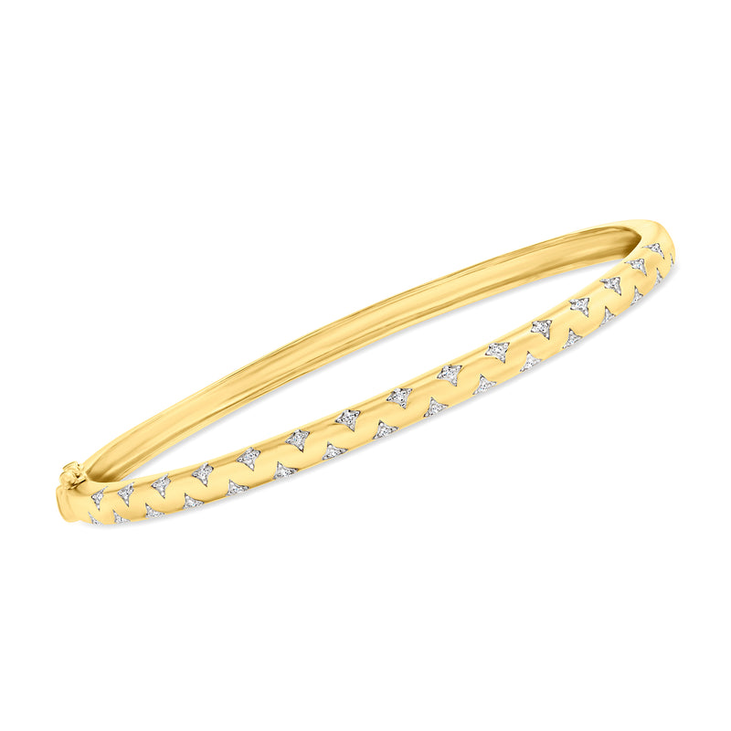 Gold-tone bangle with white enamel star pattern and small crystal accents