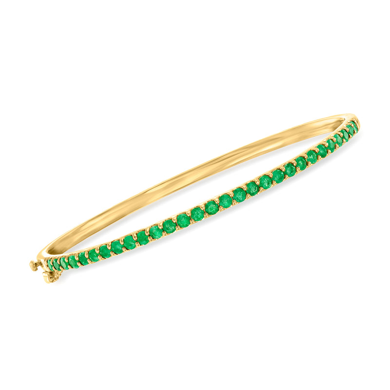Gold-tone bangle with green bead-like stones and tiny crystal accents along the band
