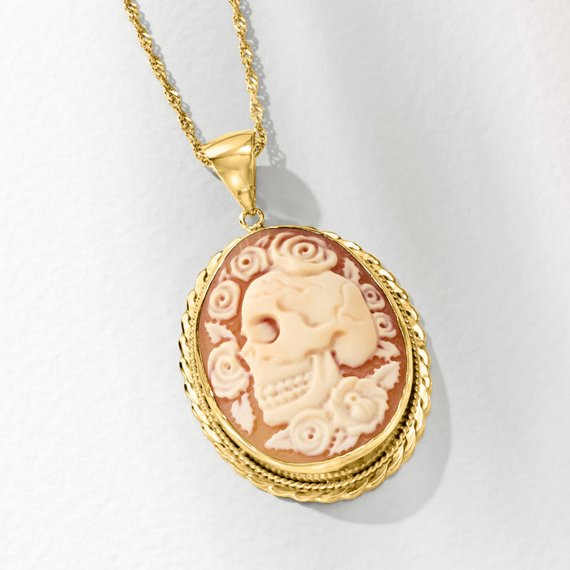 Gold oval skull cameo pendant with orange shell background and ornate rope border