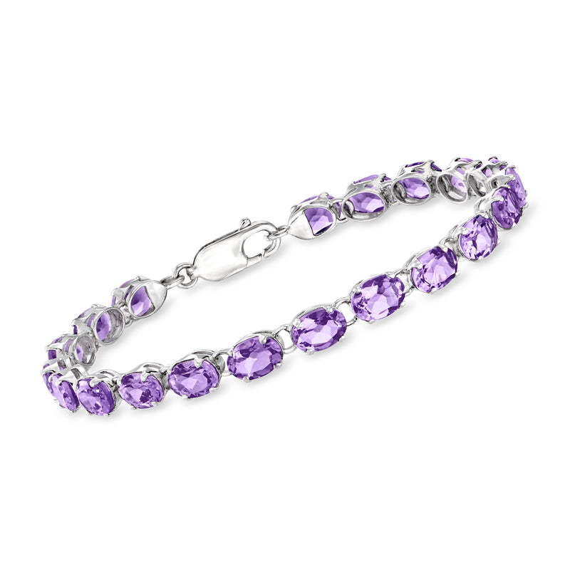Sterling silver amethyst tennis bracelet with oval purple gemstones and side clasp