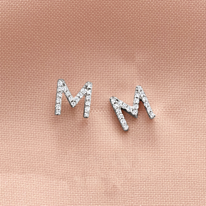 Sterling silver diamond initial stud earrings with letter M, small channel-set stones