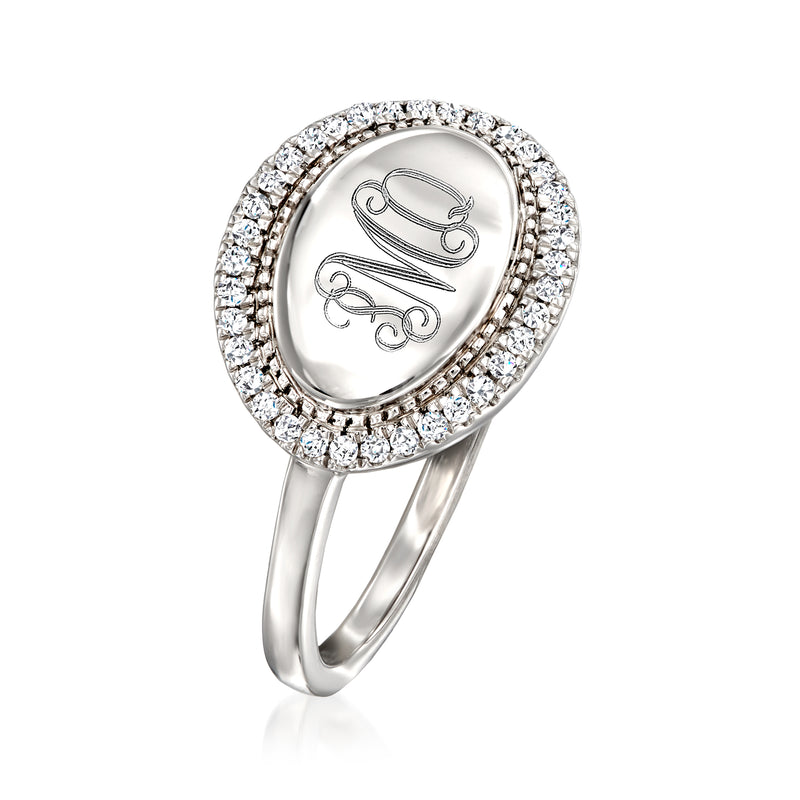Sterling silver oval diamond halo ring with scroll-style monogram on the oval center