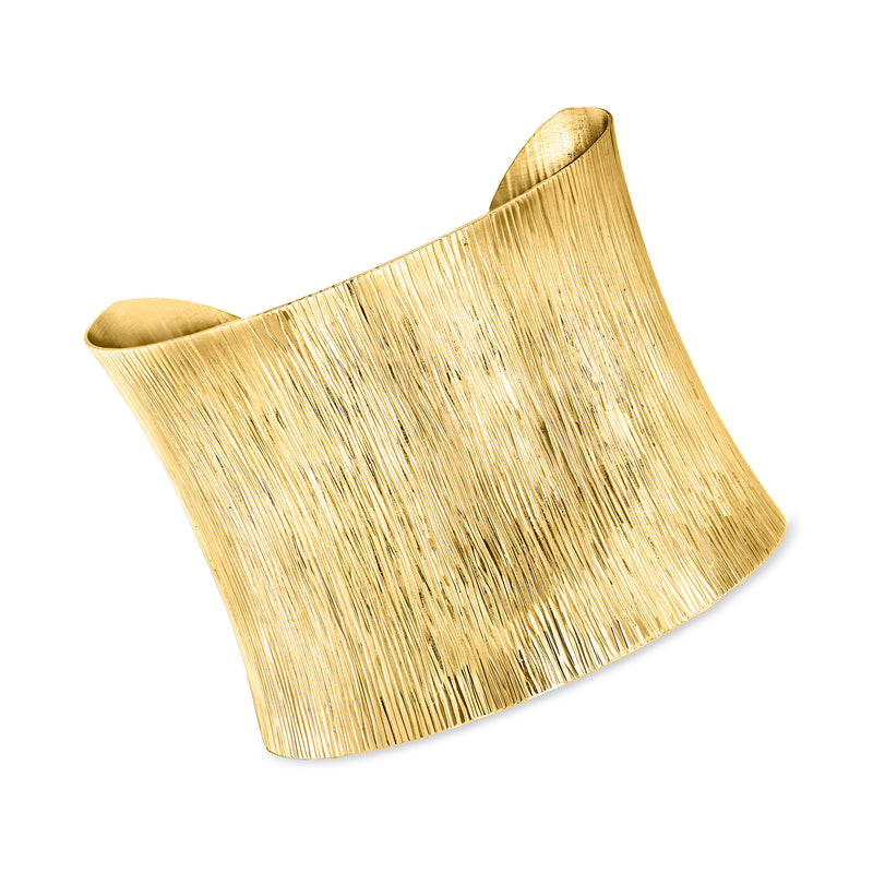 Gold over sterling wide cuff bracelet with textured vertical lines and open design.