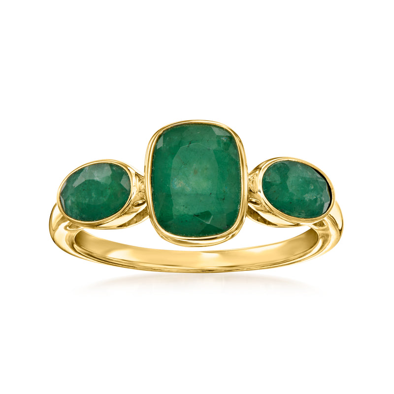 Gold three-stone ring with three green emerald-cut gemstones