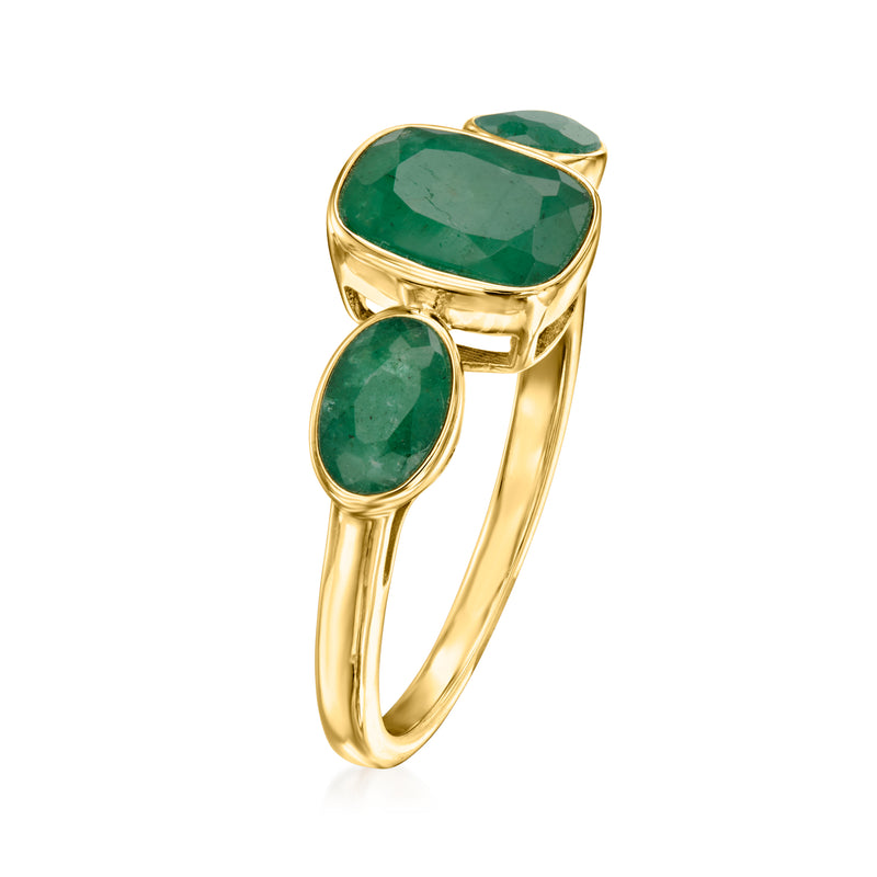 Gold three-stone ring with oval and cushion green gemstones, side view