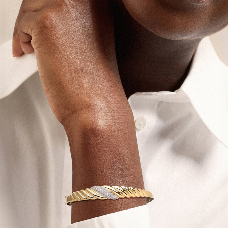 Diamond shrimp bangle bracelet in 18kt yellow gold on a wrist