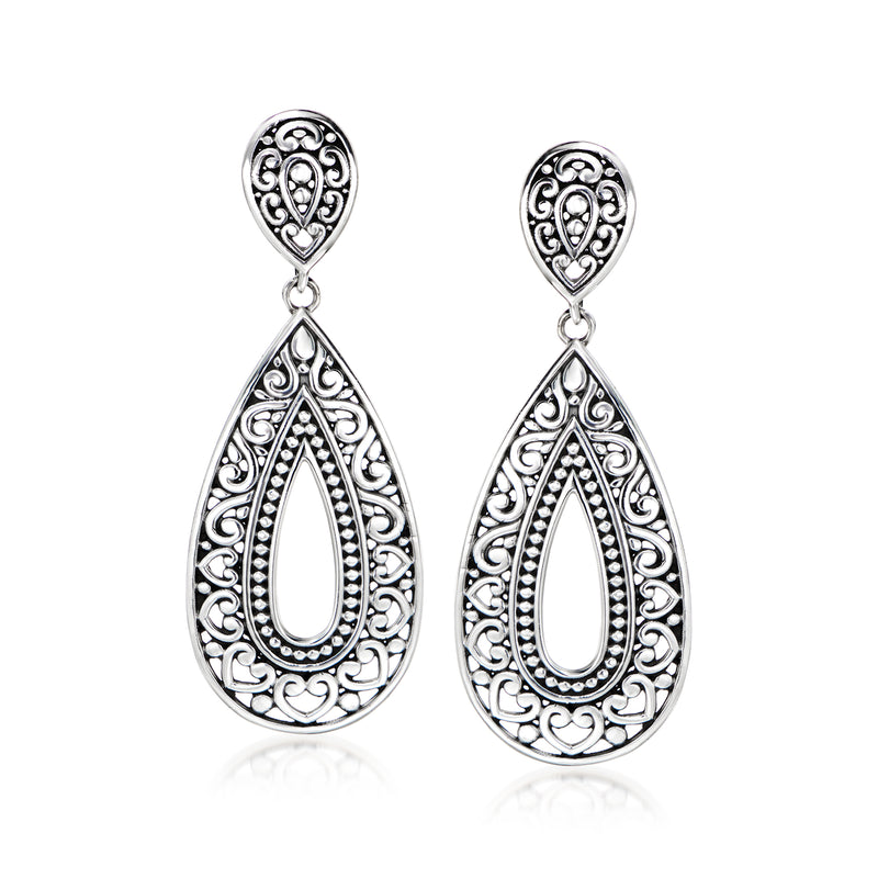Silver filigree drop earrings with teardrop cutouts and heart-like center motif