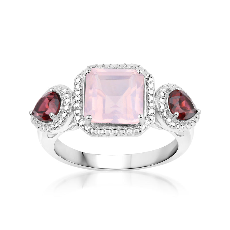 Sterling silver ring with rose quartz-style square center and red rhodolite side stones