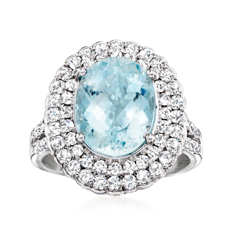 Oval aquamarine halo ring with diamond clusters, set in 18kt white gold