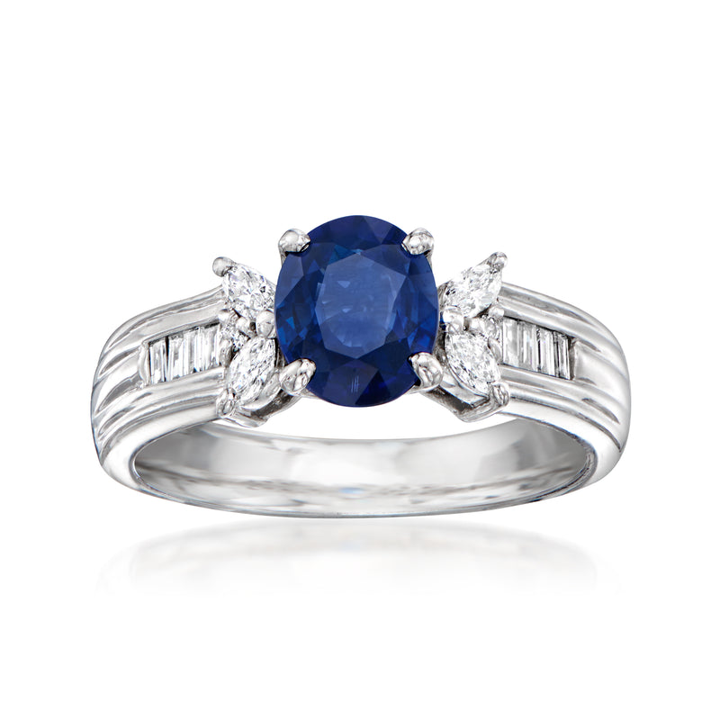 Platinum ring with oval blue sapphire center and diamond side stones, split shoulders