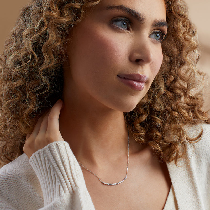 Sterling silver diamond curved bar necklace worn on model, U-shaped stone bar pendant