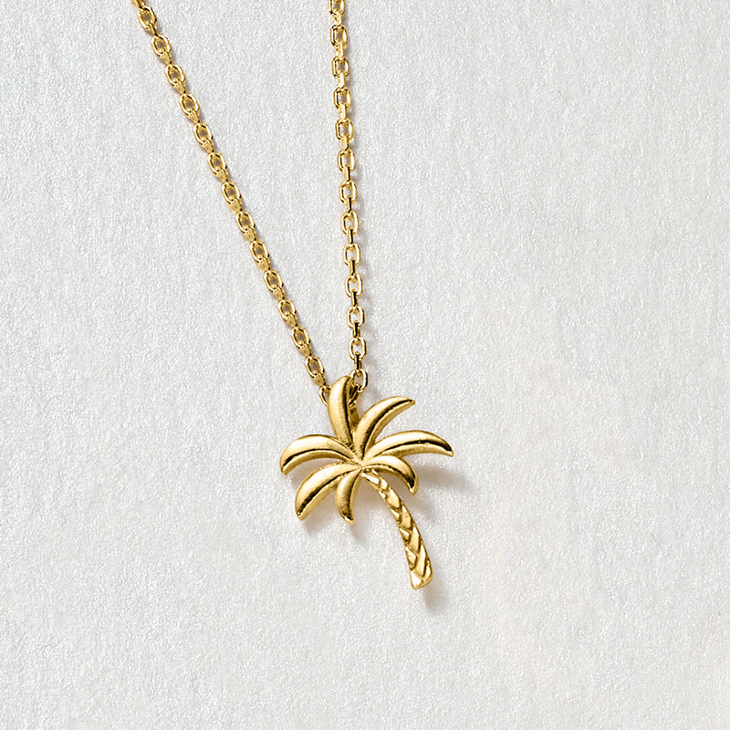 Gold palm tree pendant necklace with rope trunk detail on link chain