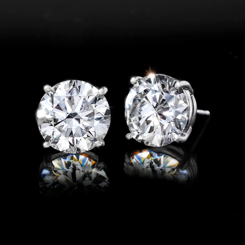 Round diamond stud earrings in white gold, side view with posts visible