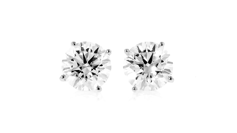 Diamond stud earrings with round brilliant stones in white gold prong settings
