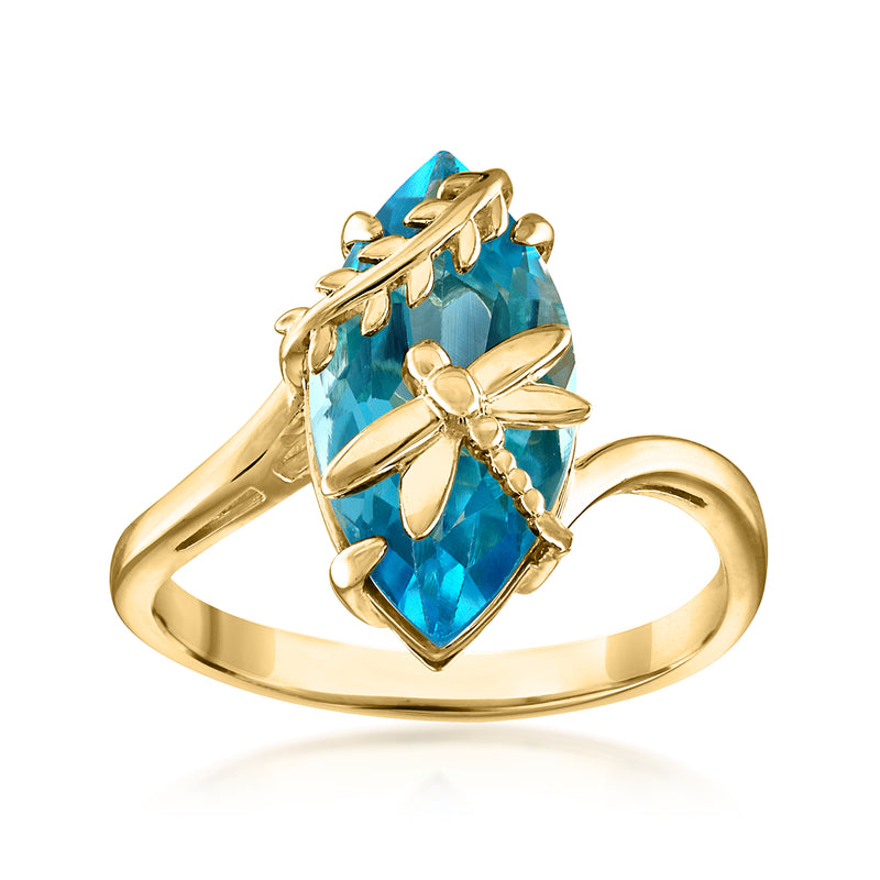 Gold-tone ring with faceted blue topaz centerpiece and dragonfly wing details