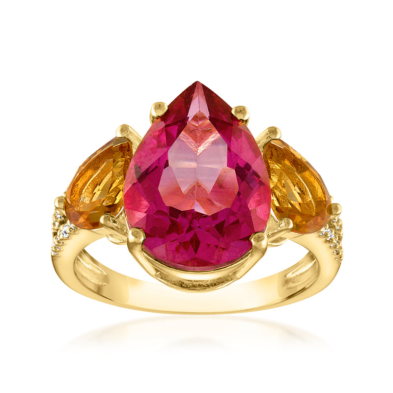 Gold-tone ring with large faceted pink gemstone center and prong-set side accents