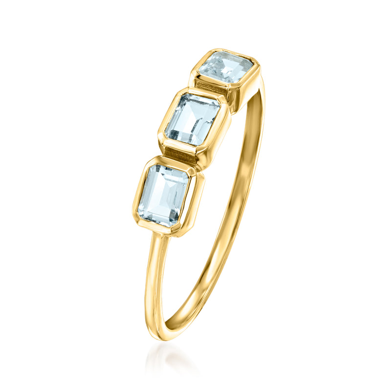 Three-stone aquamarine ring with rectangular light-blue stones in 14kt yellow gold