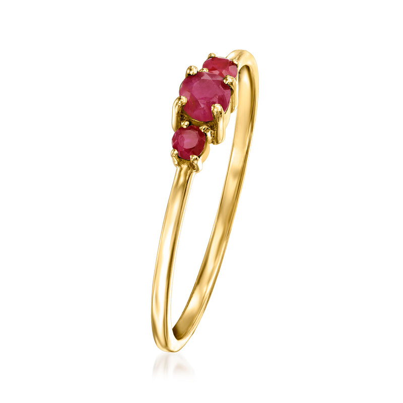 14k yellow gold side-view three-stone ruby ring with round red gemstones in prongs