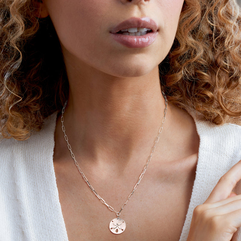 Sand dollar pendant necklace in sterling silver with round disc charm at the neckline