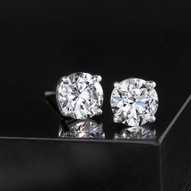 Round lab-grown diamond stud earrings, 14kt white gold, front view on dark base
