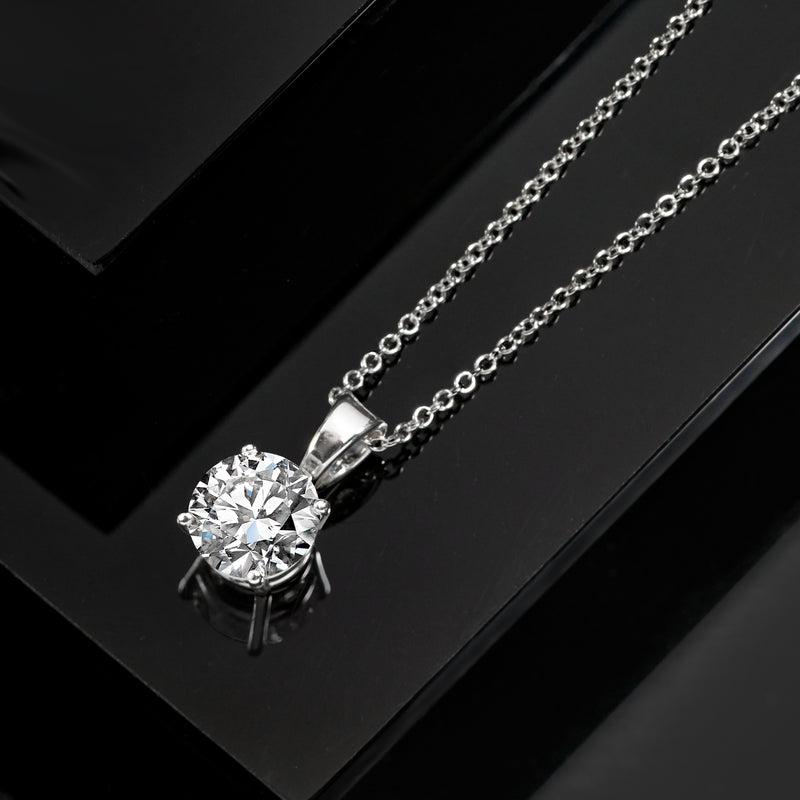 Round brilliant solitaire diamond pendant necklace on white gold chain, close-up