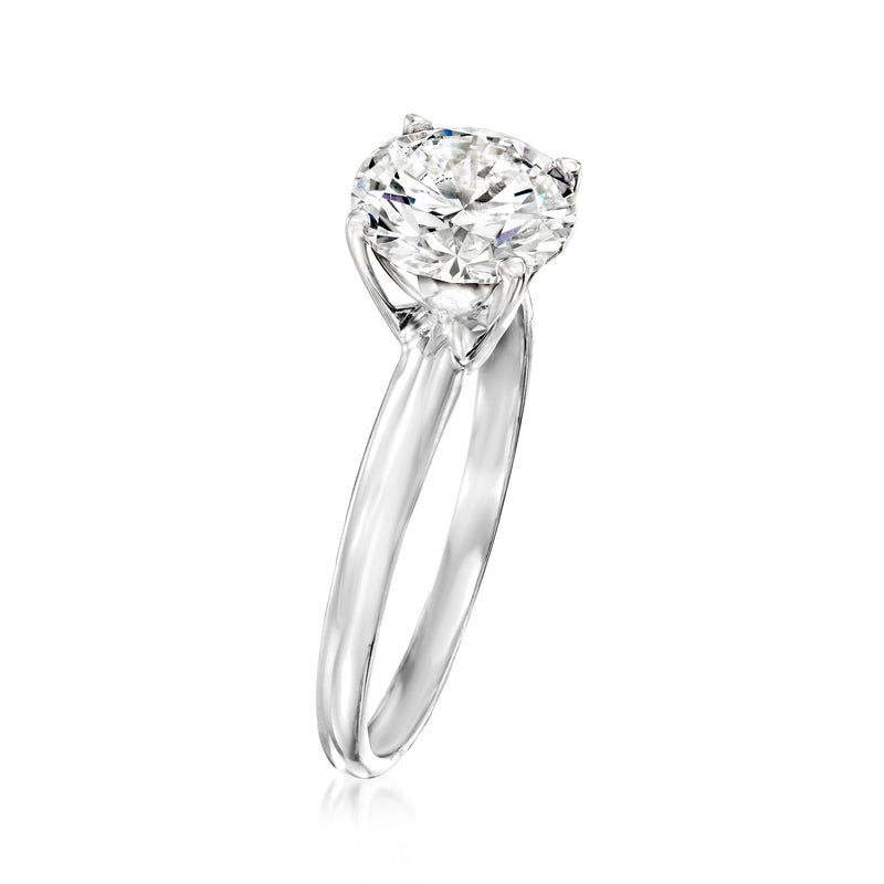 Round diamond solitaire ring, side view, four prongs on slender white gold band