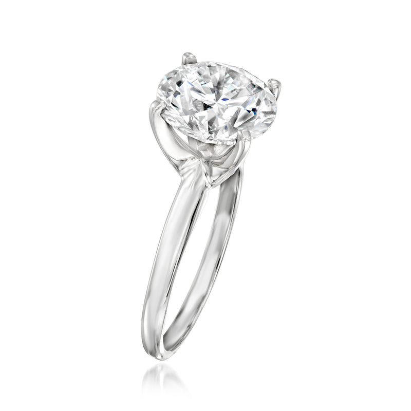 14kt white gold solitaire ring with round diamond, four-prong setting, side view