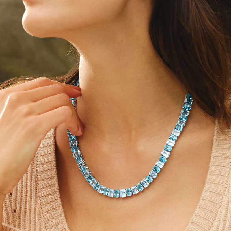 Sterling silver tennis necklace with sky-blue baguette-cut topaz; close-up