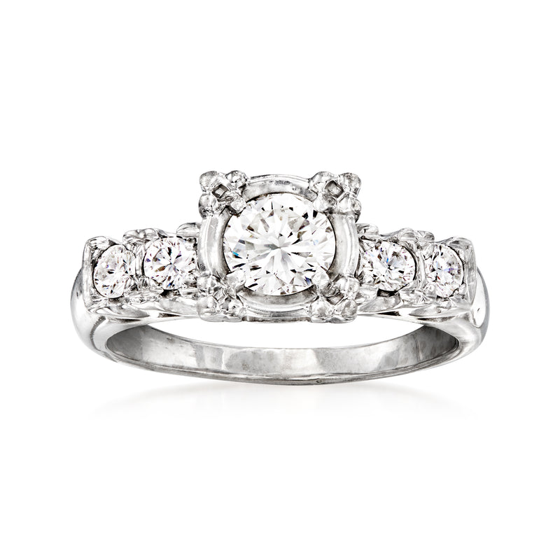 Vintage round diamond center with halo and small round diamonds on shoulders, white gold ring