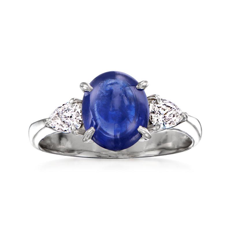 Platinum vintage ring with oval blue sapphire cabochon and two diamond clusters