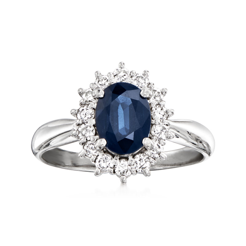 Platinum ring with oval dark-blue sapphire and diamond halo